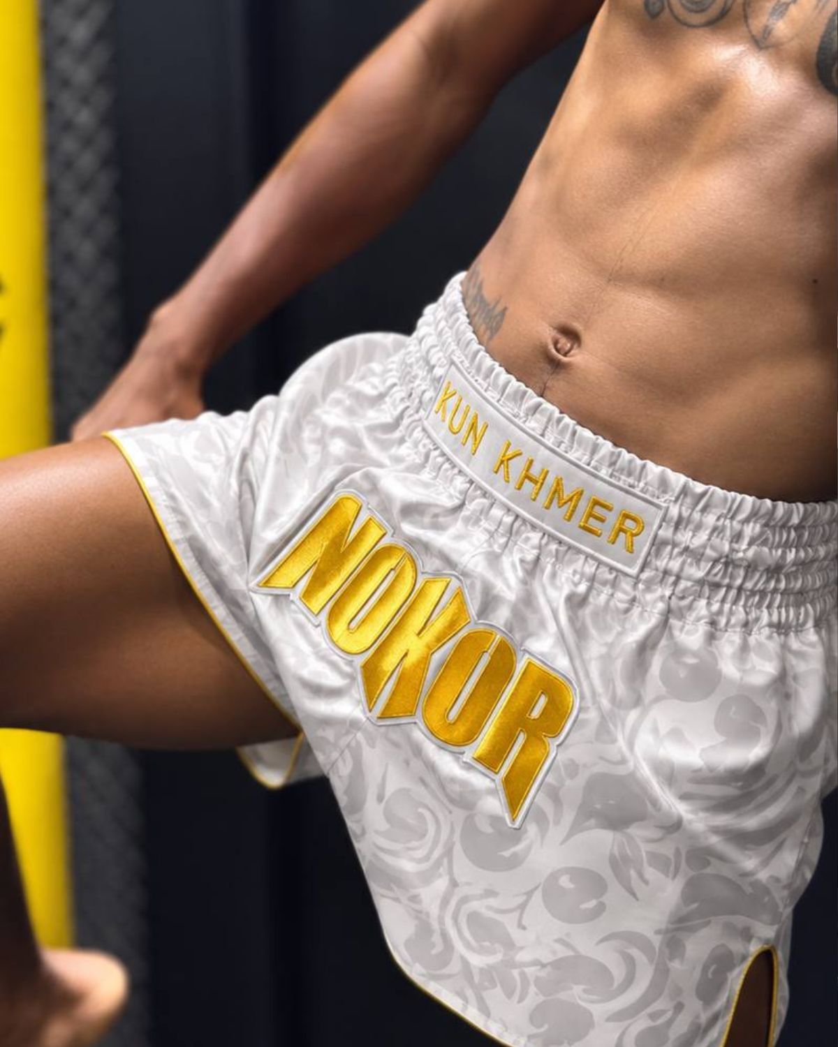 Athlete wearing white and gold NOKOR Kun Khmer shorts